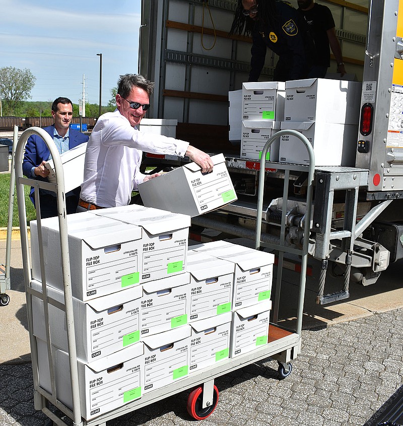 From left, John Payne and Marc Ellinger unload boxes of petitions for Legal Missouri 2022 at the Missouri Secretary of State's office Sunday, May 8, 2022. The petitions contain more than 390,000 signatures, which they believe will be more than enough to let Missourians vote to legalize recreational marijuana. Payne is the campaign manager for Legal Missouri 2022 and Ellinger is the attorney who filed the initiative petition. (Gerry Tritz/News Tribune photo)