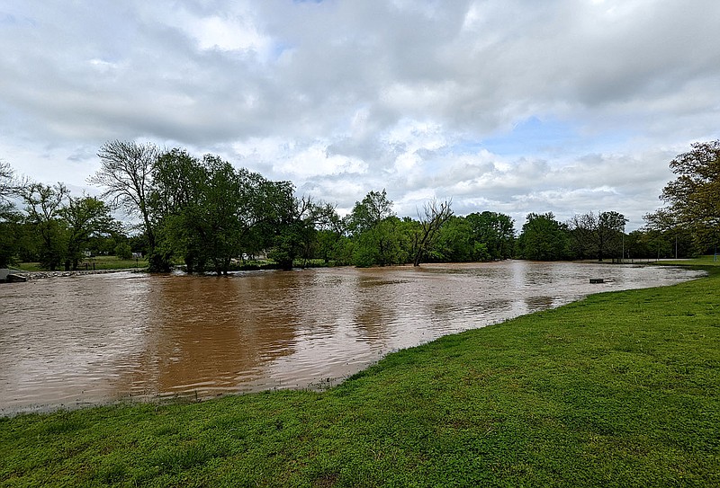 Westside Eagle Observer/RANDY MOLL Once again, the muddy floodwaters of Flint Creek rose up out of their banks along Dawn Hill East Road in Gentry following heavy rains in the area on Wednesday, May 4.