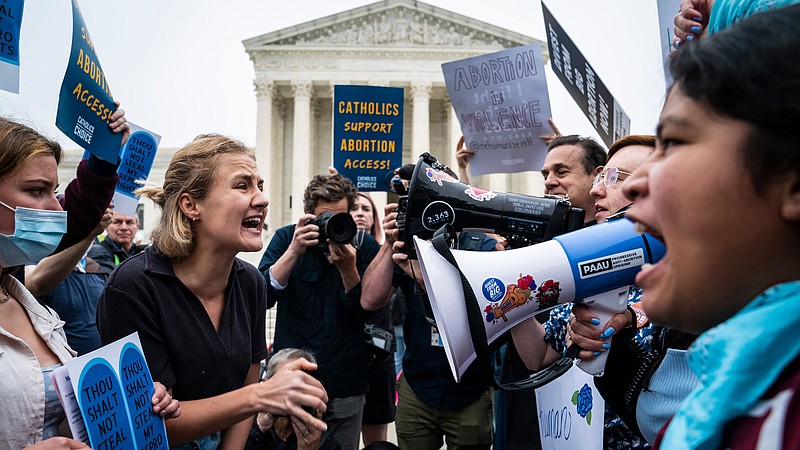 Abortion rights advocates and antiabortion advocates demonstrate outside the Supreme Court in Washington, D.C., after a leak of a draft majority opinion overturning abortion rights on Tuesday. MUST CREDIT: Washington Post photo by Jabin Botsford