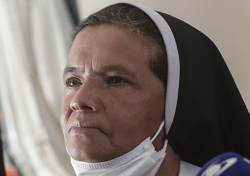 FILE &#x2014; Colombian nun Gloria Cecilia Narvaez, who was held captive for nearly five years by al-Qaida-linked militants, listens to a question during a press conference in Bogota, Colombia, in this Friday, Nov. 19, 2021 file photo. Pope Francis authorized spending up to 1 million euro to free Narvaez, Cardinal Angelo Becciu testified at the Vatican's big financial fraud trial Thursday, May 5, 2022, revealing previously top secret negotiations that Francis authorized to hire a British security and intelligence firm to find the nun and pay for her liberation. (AP Photo/Ivan Valencia)