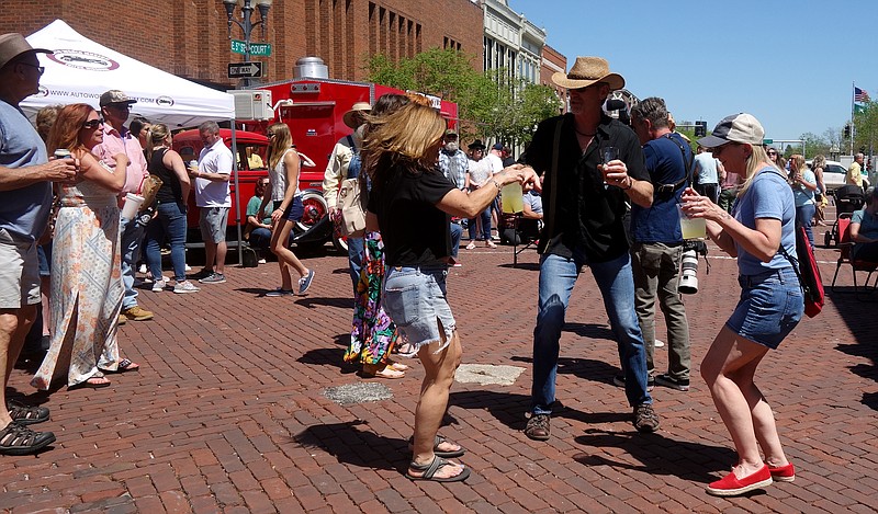 Attendees dance in the intersection of Court Street and Fifth Street in downtown Fulton on Saturday during the 10th annual Morels and Microbrews festival in 2022. (FULTON SUN/MICHAEL SHINE PHOTO)