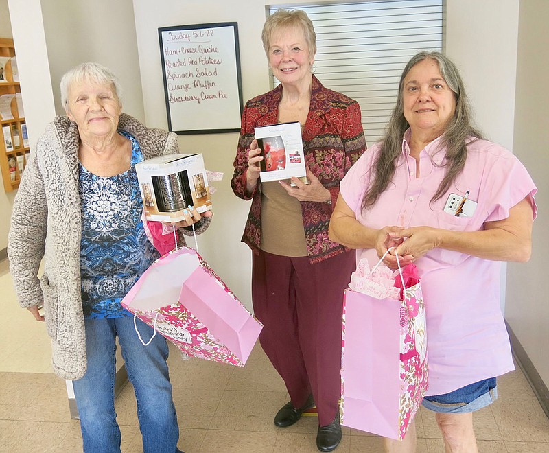 Westside Eagle Observer/SUSAN HOLLAND
Penny Leonard, Linda Schmidt and Lydia Seiden display the gifts they received for being winners in the "What's in my purse?" game during a Mother's Day celebration following lunch at the Billy V. Hall Senior Activity and Wellness Center Friday afternoon, May 6. Penny was the first-place winner and Linda and Lydia tied for second and third place in the game. Each received a wax melt warmer.