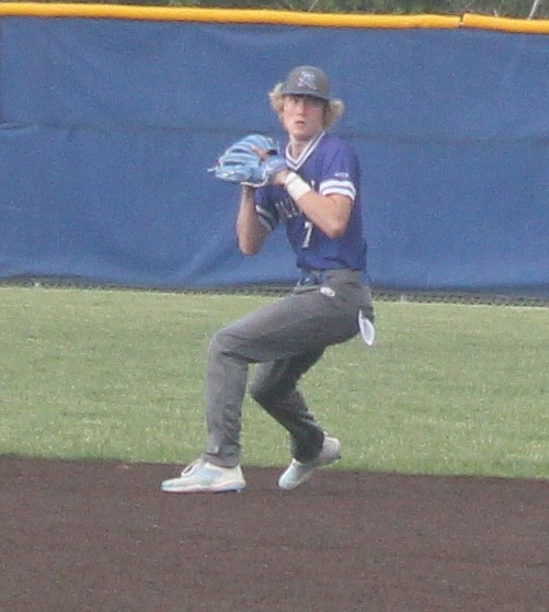 Senior Isaiah Kauffman throws over to first base for an out in the second inning. (Photo by Evan Holmes)