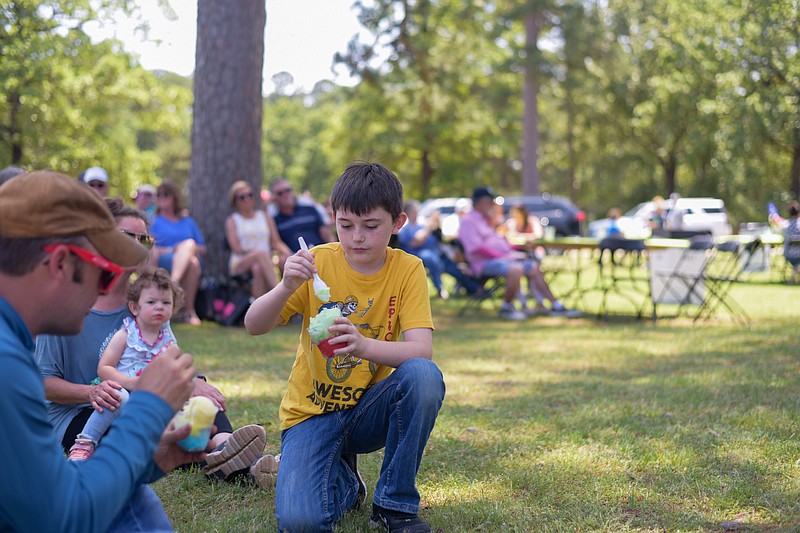 Samuel Morris enjoys a frozen treat as his other families dine on the lawn during the Twice as Fine Wine Festival on Saturday, May 7, 2022, at Spring Lake Park in Texarkana, Texas. The festival is a major fundraiser for Alzheimer’s Alliance Tri-State Area and Our Place Respite Care Center. Wineries from across Texas, a number of merchants and local businesses -- not mention live music -- were part of the event, which gave visitors an opportunity to taste and purchase wines and gourmet treats. (Staff photo by Erin DeBlanc)