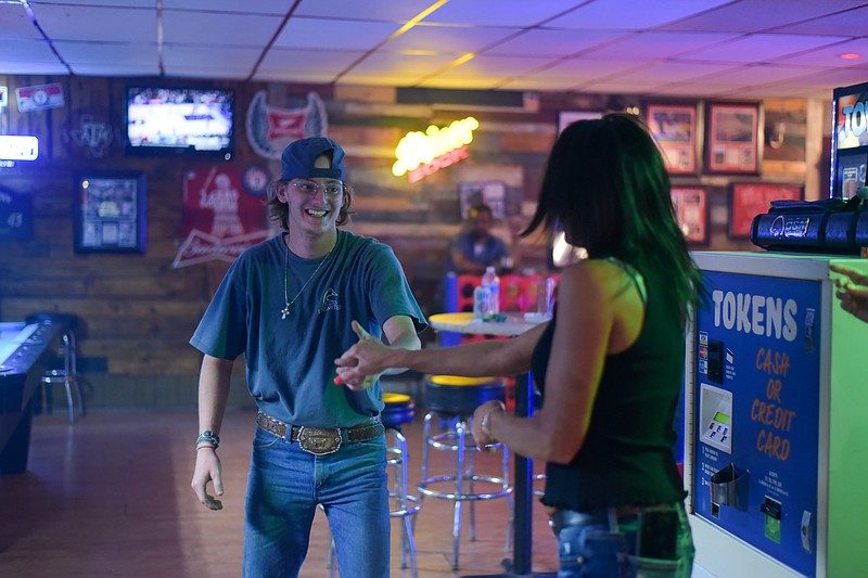 Brady Hayes and Kimberley Haworth dance Friday, May 6, 2022, at the Arrow Bar in Texarkana, Arkansas. (Staff photo by Erin DeBlanc)