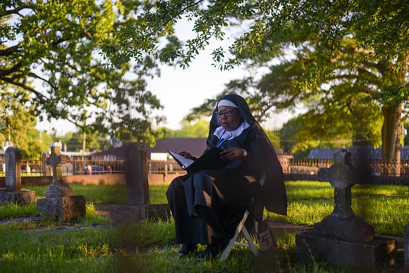 Living history actors portray historical figures of Texarkana's past during the Texarkana Museums System Twilight Tours. One important person was Sister Mary Justine, who travelled to Texarkana in the late 1800's to establish a school at Sacred Heart Catholic Church. Shown is the portrayal of Sister Justine during the May 7 tour of Sacred Heart Cemetery in Texarkana, Texas. (Staff photo by Erin DeBlanc)