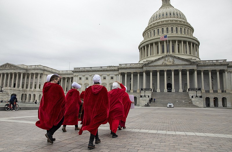 Abortion-rights protesters dressed in costumes from the “Handmaid’s Tale” walk to the U.S. Capitol building during a demonstration in Washington, Sunday, May 8, 2022. A draft opinion suggests the U.S. Supreme Court could be poised to overturn the landmark 1973 Roe v. Wade case that legalized abortion nationwide, according to a Politico report released Monday.

(AP Photo/Amanda Andrade-Rhoades)