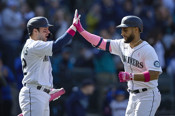 Seattle Mariners' Luis Torrens reacts after he slid safely home to score on  a RBI single hit by Ty France during the sixth inning of a baseball game  against the Houston Astros