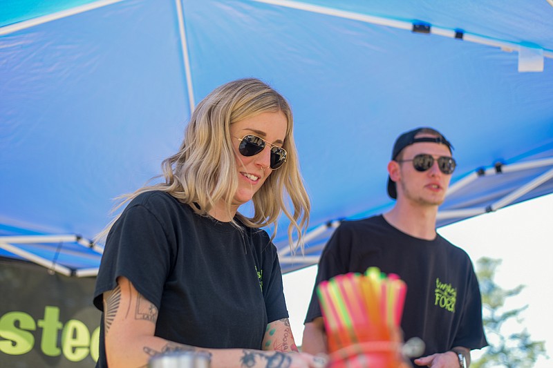 Bri Flanagan works the Twisted Fork station at the Twice as Fine Wine Festival on Saturday, May 7, 2022, at Spring Lake Park in Texarkana, Texas. The festival is the preeminent fundraiser for the Alzheimer's Alliance Tri-State Area. (Staff photo by Erin DeBlanc)