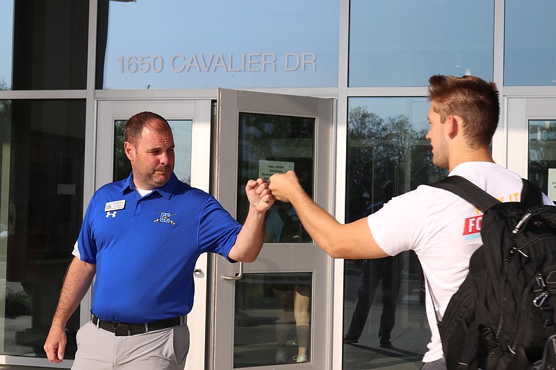 Anna Campbell/News Tribune photo: 
Capital City High School Principal Ben Meldrum greets 2022 Senior Hunter Schulte with a fist bump as he heads into the school Monday, May 9, 2022. Meldrum greets students everyday.