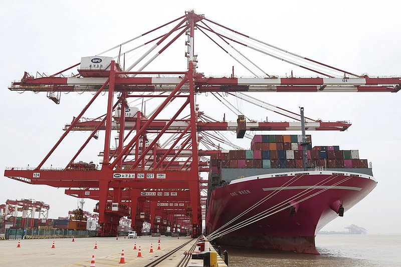 In this photo released by Xinhua News Agency, a container ship from Japan is anchored at the container dock of Shanghai's Yangshan Port in east China on April 27, 2022. China's export growth tumbled in April after Shanghai and other industrial cities were shut down to fight virus outbreaks. (Chen Jianli/Xinhua via AP)