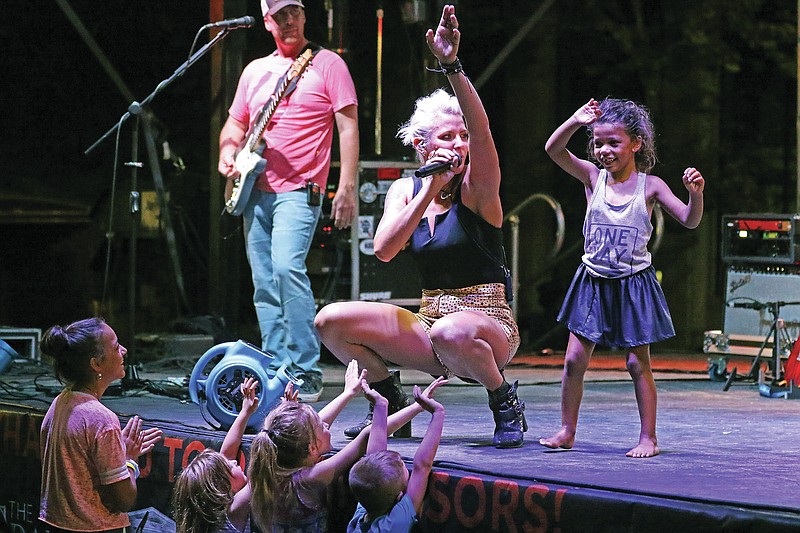 A group of young concertgoers surround ChristiAna as she sings "I Want you to Want Me" by Cheap Trick during a previous Thursday Night Live on High Street in downtown Jefferson City. (Jason Strickland/News Tribune file photo)
