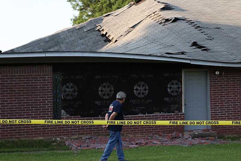 Nash Fire Department firefighter Larry Fountain inspects the damage to Greater Shiloh Church of God in Christ after its roofed collapsed Monday evening, May 9, 2022. No one was injured in the collapse, which remains under investigation. The church is at 201 Clark St. in Nash. (Photo by JD)