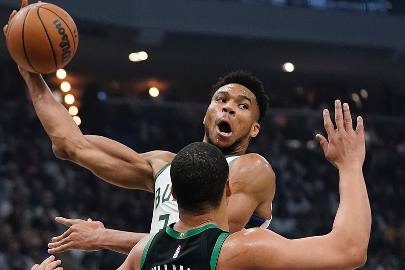 Milwaukee Bucks' Giannis Antetokounmpo looks to pass around Boston Celtics' Grant Williams during the first half of Game 4 of an NBA basketball Eastern Conference semifinals playoff series Monday, May 9, 2022, in Milwaukee. (AP Photo/Morry Gash)