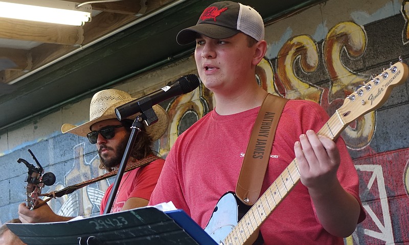 One of the best-known young players for the first Saturday outdoor music fest at the county Music Store is 14-year-old Anthony Price. That’s Colt Williams playing with him right behind. (Photo by Neil Abeles)