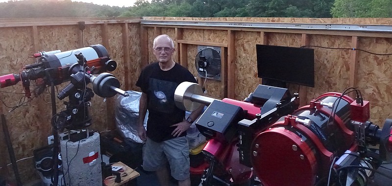 Jan Porter shows his two major instruments, the large field and the narrow field celestial telescopes on their concrete posts ready to be turned upward to the sky. (Photo by Neil Abeles)