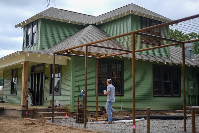 Reliance Mechanical employees work on renovating the early 1900s house at 330 E. New Boston Road in Nash, Texas. Since December 2021, Cody Peek and Dr. Joshua Wiggins have worked to renovate the home into their new coffee shop, Local Habit Coffee Co., scheduled to open May 21. (Staff photo by Erin DeBlanc)