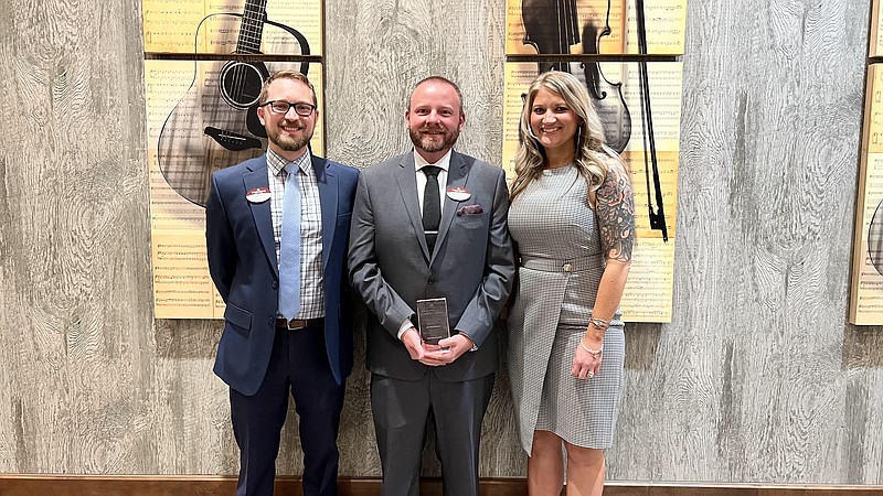 Accepting the Distinguished Communities of the Year award at the company's leadership retreat in Nashville were: Dylan Kessler (left), Primrose Jefferson City director of operations; Brandon McEntire, executive director; and Ashley Hofland, operations manager. (Courtesy/Primrose)