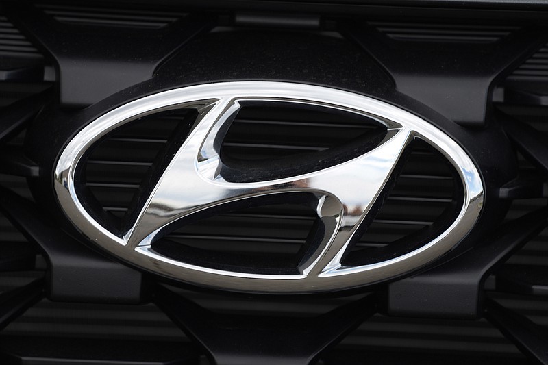 FILE - The Hyundai logo shines off the grille of an unsold vehicle at a Hyundai dealership Sunday, Sept. 12, 2021, in Littleton, Colo.  Hyundai is recalling more than 215,000 midsize cars in the U.S., Wednesday, May 11, 2022,  most for a second time _ because fuel hoses can leak in the engine compartment and cause fires. The recall covers certain 2013 and 2014 Sonata sedans, many of which were recalled for the same problem in 2020.  AP Photo/David Zalubowski, File)
