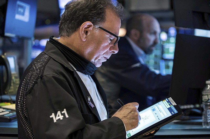 In this photo provided by the New York Stock Exchange, trader Sal Suarino works on the floor, Wednesday, May 11, 2022. Stocks fell on Wall Street Wednesday after inflation slowed last month but still came in worse than feared. (Courtney Crow/New York Stock Exchange via AP)