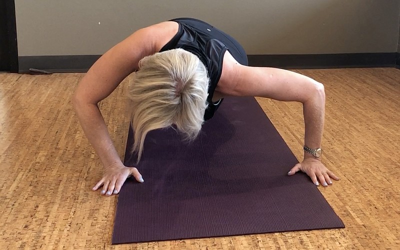 Registered yoga teacher Natalie Staley demonstrates Diagonal Pushups at Little Rock Racquet Club for Matt Parrott's Master Class. (Democrat-Gazette photo illustration/Celia Storey)