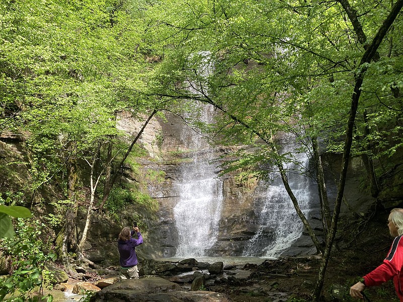 The twin cascades of High Bank waterfall are a sight to behold on May 6 2022 along the Mulberry River Road Scenic Byway. Heavy rain the first week of May got waterfalls flowing across the region creating ideal opportunity for waterfall hikes. Karen and Tom Mowry reached the waterfall on a short trail from the highway to the waterfall.
(NWA Democrat-Gazette/Flip Putthoff)