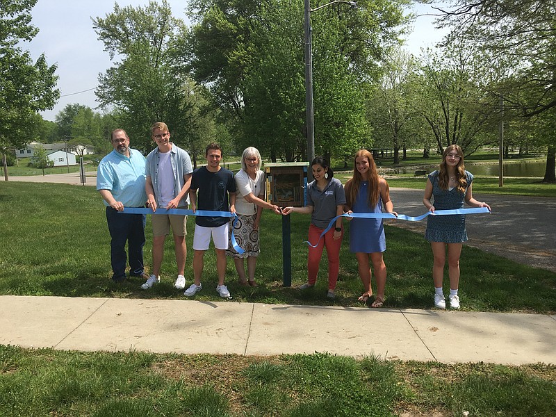 Library Director Connie Walker and Central Missouri Community Action (CMCA) community organizer Jenn Millard cut the ribbon to the Little Free Libraries project with California High School students and faculty on May 11, 2022. Pictured (left to right) are: CHS Art Teacher Brad Friedrich, student Treston Lewis, student Ryan Staton, Moniteau County Library Connie Walker, Central Missouri Community Action Community Organizer Jenn Milliard, student Ellie Clay and student Grace Porter. (Democrat photo/Evan Holmes)