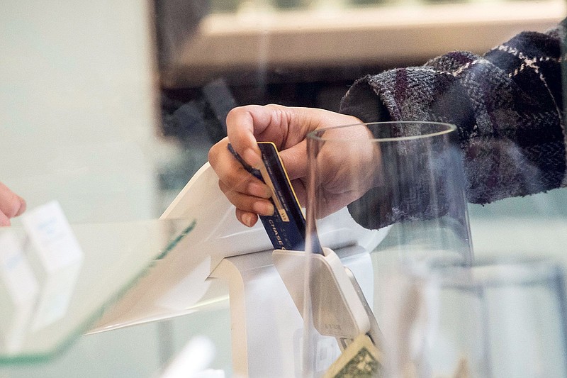 A customer inserts a credit card into Square Inc. device while making a payment in San Francisco on March 27, 2018. MUST CREDIT: Bloomberg photo by David Paul Morris.