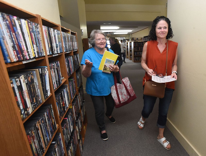 Jane Matthews (left) and Jennifer Fielding shop Tuesday May 10 2022 for books at the new Friendly Bookstore location, 1114 W. Poplar Place in Rogers. The store sells all genres of used books, plus movies and games. Friendly Bookstore accepts donations during business hours of used books in good condition. Hours are 11 a.m. to 3 p.m. Tuesday through Saturday. Go to nwaonlne.com/220516Daily/ to see more photos.
(NWA Democrat-Gazette/Flip Putthoff)