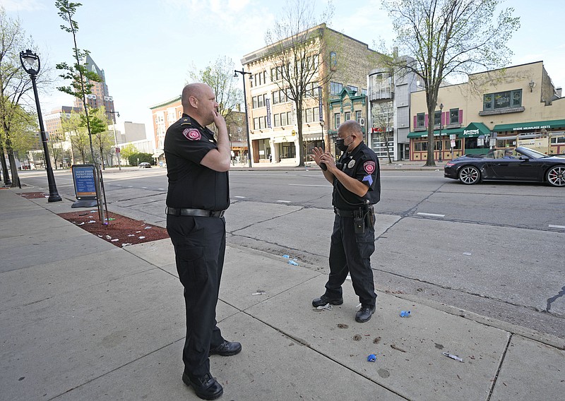 MSOE Public Safety officers investigate the scene of a shooting near the corner of North Water Street and East Juneau Avenue Saturday in Milwaukee, where multiple were shot and injured late Friday in Milwaukee's downtown bar district after the Milwaukee Bucks playoff game. - Photo by Mike De Sisti of Milwaukee Journal-Sentinel via The Associated Press