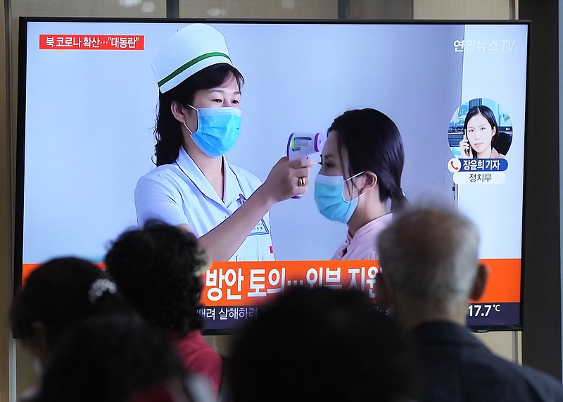 People watch a TV screen showing a news report about the COVID-19 outbreak in North Korea, at a train station in Seoul, South Korea, Saturday, May 14, 2022. North Korea on Saturday reported 21 new deaths and 174,440 more people with fever symptoms as the country scrambles to slow the spread of COVID-19 across its unvaccinated population. (AP Photo/Ahn Young-joon)