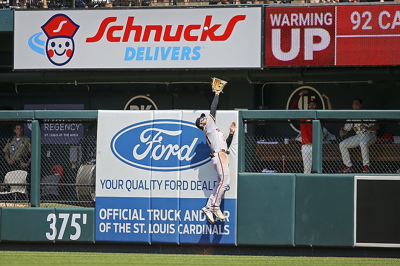 San Francisco Giants right fielder Luis Gonzalez (51) is unable to catch a solo home run hit by St. Louis Cardinals' Tommy Edman during the fifth inning of a baseball game Saturday, May 14, 2022, in St. Louis. (AP Photo/Scott Kane)