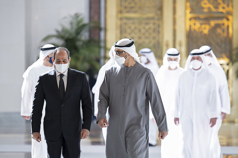 This photo provided by the Ministry of Presidential Affairs, shows Egyptian President Abdel Fattah El Sisi, left, walking with Sheikh Mohamed bin Zayed Al Nahyan, the new President of the United Arab Emirates, on his arrival to offer offers condolences on the death of Sheikh Khalifa bin Zayed Al Nahyan, the late President of the UAE, at the Presidential Airport in Abu Dhabi, UAE, Saturday, May 14, 2022.  (Mohamed Al Hammadi/Ministry of Presidential Affairs via AP)