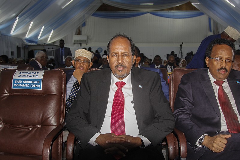 Presidential candidates, former President Hassan Sheikh Mohamud, center, and incumbent leader Mohamed Abdullahi Mohamed, right, attend a voting session for the presidential election at the Halane military camp which is protected by African Union peacekeepers, in Mogadishu, Somalia on Sunday, May 15, 2022. Legislators in Somalia are meeting Sunday to elect the country's president in the capital, Mogadishu, which is under lockdown measures aimed at preventing deadly militant attacks. (AP Photo/Farah Abdi Warsameh)