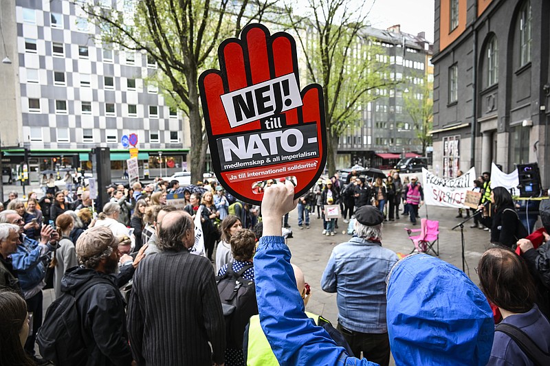 FILE - Protesters gather during a demonstration against NATO membership outside the ruling Social Democrats party's office in Stockholm, Sweden, May 14, 2022. Security concerns over Russia’s ongoing invasion of Ukraine changed the calculus for Finland and Sweden which have long espoused neutrality and caused other traditionally “neutral” countries to re-think what that term really means for them. (Anders Wiklund/TT via AP, File)