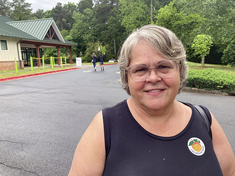 Debbie Hamby, 66, casts a ballot at an early voting site in Acworth, Ga., on Friday, May 6, 2022. Hamby, a nurse from Kennesaw, Georgia, says she believes in-person voting is more secure and supports limits on mail ballots. (AP Photo/Christina A. Cassidy)