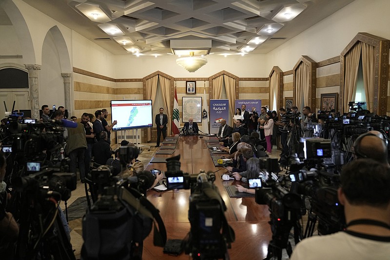 Lebanese Interior Minister Bassam Mawlawi, center, speaks during a press conference about Sunday's parliamentary elections, at the interior ministry in Beirut, Lebanon, Monday, May 16, 2022. Lebanon's militant Hezbollah group and its allies suffered losses in this weekend's parliamentary elections, with preliminary results Monday showing some of their most vocal opponents picking up more seats and several of their traditional partners routed out of the legislature. (AP Photo/Hassan Ammar)