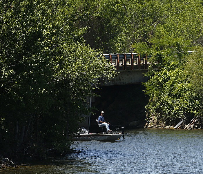 A fisherman casts his line in the water while fishing under the Hwy. 10 on Monday, May 16, 2022, at Lake Maumelle. 
(Arkansas Democrat-Gazette/Thomas Metthe)