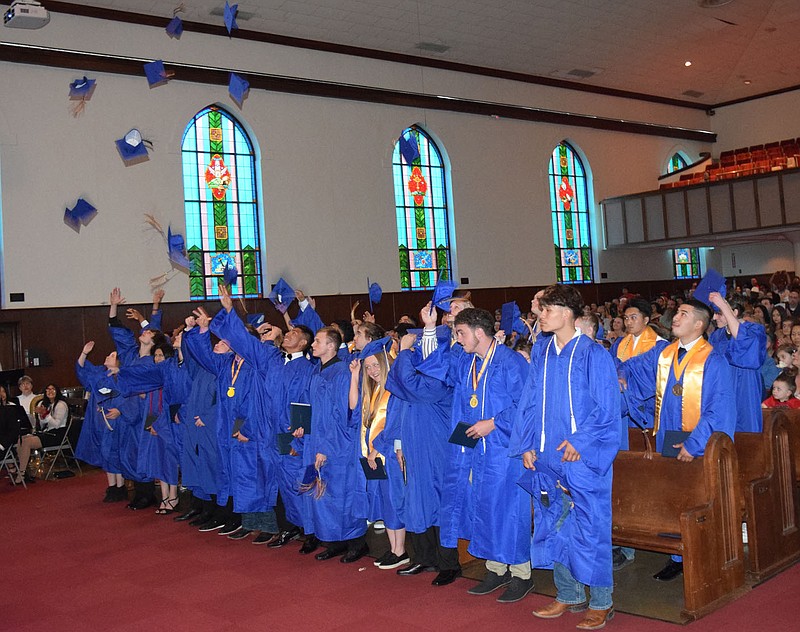 Westside Eagle Observer/MIKE ECKELS Hats fly as the Decatur High Class of 2022 celebrates its newfound freedom during the 2022 Decatur High School Commencement Ceremony at the Cathedral of the Ozarks on the campus of John Brown University in Siloam Springs on Friday.