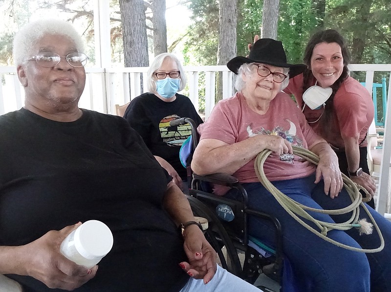 “Let’s see how a cowgirl hat goes with your rope,” said Kayla Stanley, right, director of rehabilitation, to Alice Story. Dorothy Hudspeth and Teresa Blythe are also pictured. It’s all part of National Skilled Nursing Care Week. (Photo by Neil Abeles)