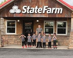PHOTO PROVIDED BY JANICE BEARBOWER. Caleb Littlefield, State Farm employee, is coaching Pineville's T-ball team this summer. State Farm is working to get involved in more community events.
