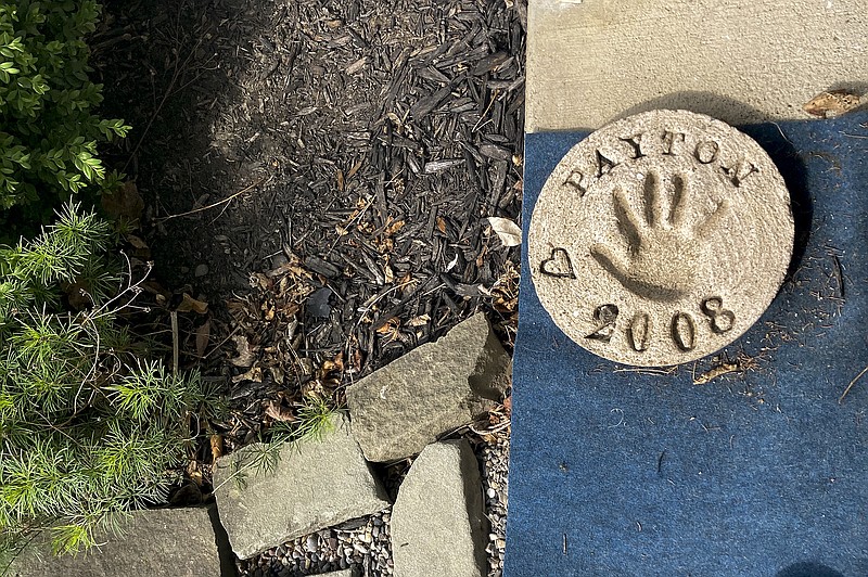 A plaster imprint of Payton Gendron's hand from 2008 sits on the front porch of his home, Monday, May 16, 2022, in Conklin, N.Y. Authorities say the white 18-year-old who killed 10 people at a Buffalo supermarket during a rampage that targeted Black people had previously made a threat at his high school. But they say Payton Gendron was never charged with a crime and had no further contact with law enforcement after his release from a hospital. (AP Photo/Michael Hill)