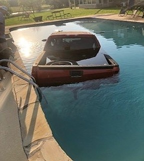 A truck is seen partially submerged in a swimming pool at a residence near DeKalb, Texas. The driver, Erik Scott Shirley, 28, has been charged with criminal mischief. (Photo by Bowie County Sheriff’s Office)