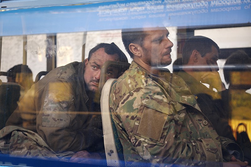 The Associated Press
Ukrainian servicemen sit in a bus after they were evacuated from the besieged Mariupol's Azovstal steel plant, near a remand prison in Olyonivka, in territory under the government of the Donetsk People's Republic, eastern Ukraine, Tuesday.