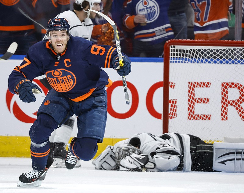 Los Angeles Kings goalie Jonathan Quick, right, lies on the ice as Edmonton Oilers center Connor McDavid celebrates his goal during the third period in Game 7 of a first-round series in the NHL hockey Stanley Cup playoffs Saturday, May 14, 2022, in Edmonton, Alberta. (Jeff McIntosh/The Canadian Press via AP)