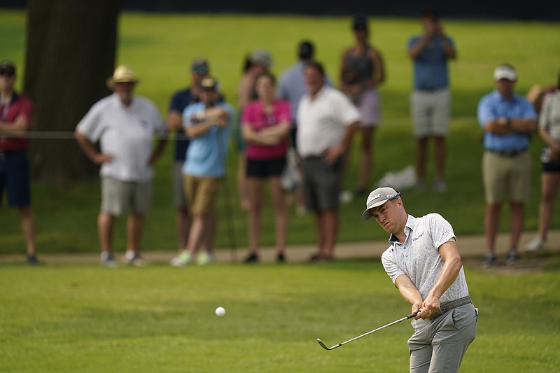 Justin Thomas chips to the green on the seventh hole during a practice round for the PGA Championship golf tournament, Tuesday, May 17, 2022, in Tulsa, Okla. (AP Photo/Eric Gay)