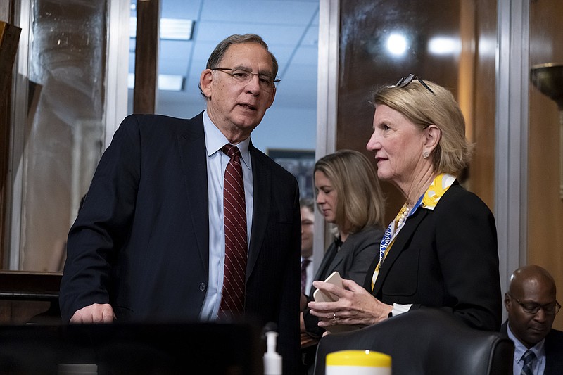 Sen. John Boozman, R-Ark., left, confers with Sen. Shelley Moore Capito, R-W.Va., the ranking member of the Senate Committee on Environment and Public Works, at the start of a business meeting to advance the Water Resources Development Act of 2022, at the Capitol in Washington, Wednesday, May 4, 2022. (AP Photo/J. Scott Applewhite)