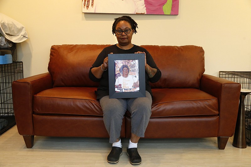 Pamela Merritt, executive director of Medical Students for Choice, sits in her living room in southern Illinois on Monday, April 11, 2022. She is holding an illustration created by a former coworker, Caitlin Blunnie, which includes one of Merritt's favorite rallying cries: "When they go low, we organize!" Merritt considers access to abortion a civil rights issue — and vows to fight to help maintain that access if the U.S. Supreme Court upholds Mississippi's ban on abortions after 15 weeks of pregnancy. Whatever that decision is, Merritt says, "There's an active, organized crew of people who are going to do what it takes to try and make sure that people aren't denied their bodily autonomy and it's not a march, it's not a rally, it's not a chant. It's different, and in many ways it does resemble some of the resistance work that took place in the late 60s, early 70s." (AP Photo/Martha Irvine)