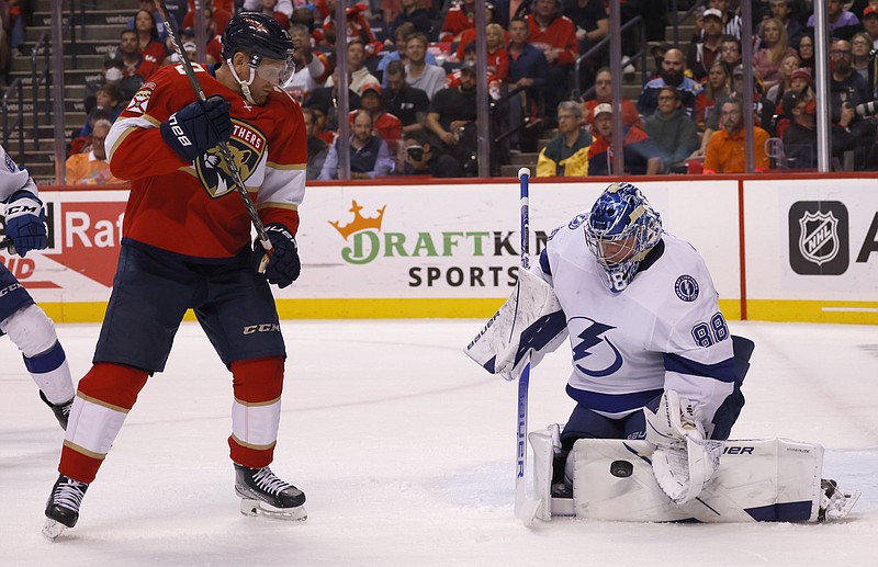 Florida Panthers right wing Patric Hornqvist (70) watches as Tampa Bay Lightning goaltender Andrei Vasilevskiy (88) deflects the puck during the second period of Game 1 of an NHL hockey second-round playoff series Tuesday, May 17, 2022, in Sunrise, Fla. (AP Photo/Reinhold Matay)