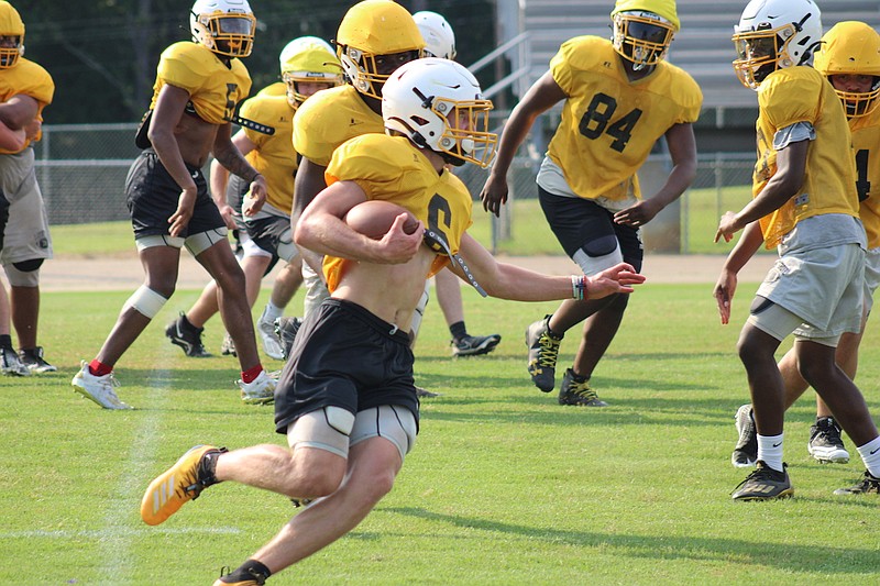 Photo By: Michael Hanich
Harmony Grove running back/receiver Landon Garrett runs for a first down in practice.